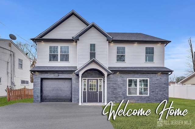 28 Kenmore Rd, Edison, NJ 08817 - traditional-style house featuring stone siding, an attached garage, and asphalt driveway