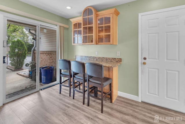 20 Sassafras Ct, North Brunswick, NJ 08902 - kitchen featuring light wood-style floors, glass insert cabinets, light brown cabinets, recessed lighting, and light stone countertops