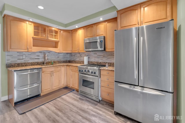 20 Sassafras Ct, North Brunswick, NJ 08902 - kitchen featuring appliances with stainless steel finishes, a sink, light stone countertops, glass insert cabinets, and light wood-style flooring