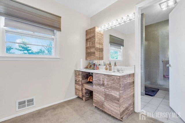 full bathroom with baseboards, vanity, visible vents, and tile patterned floors