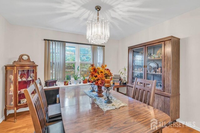 dining room featuring light wood finished floors and a notable chandelier