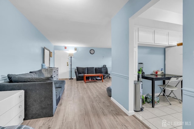 living room with baseboards and light wood-style floors