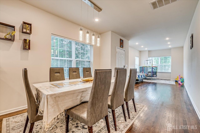 dining area with wood finished floors, baseboards, and recessed lighting