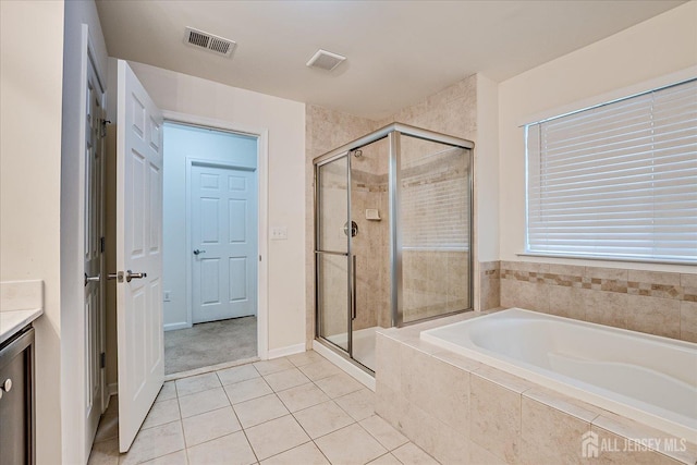 full bath featuring a shower stall, a garden tub, tile patterned flooring, and vanity