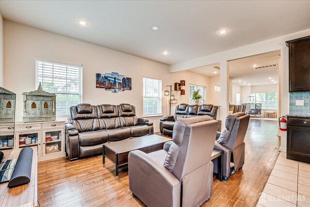 living room with light wood-style floors and recessed lighting