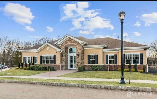 view of front of property with a front yard and brick siding