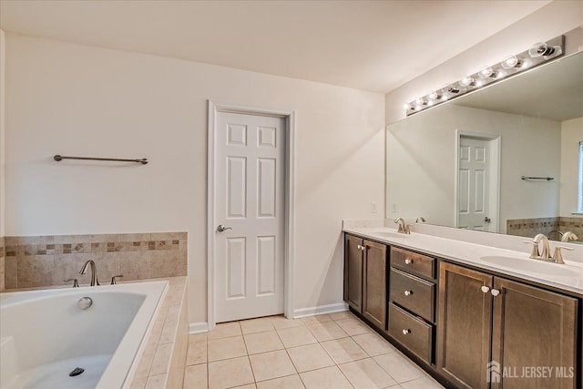 full bath featuring tile patterned floors, a bath, double vanity, and baseboards