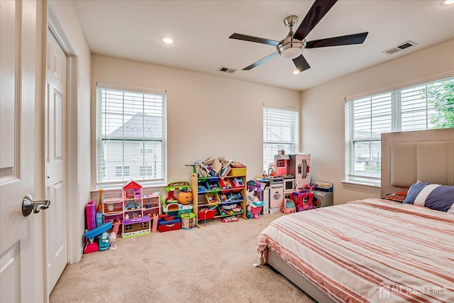 carpeted bedroom featuring multiple windows, recessed lighting, and ceiling fan