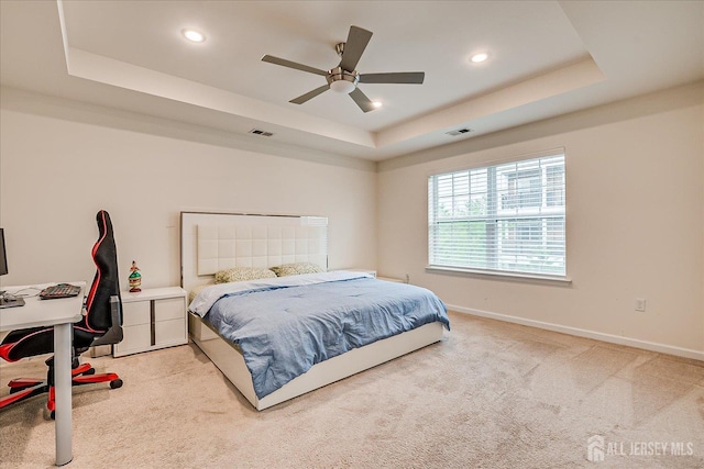 bedroom with a tray ceiling, carpet floors, baseboards, recessed lighting, and a ceiling fan