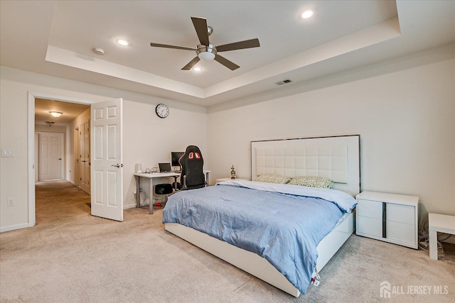 bedroom with carpet floors, a raised ceiling, recessed lighting, baseboards, and an office area