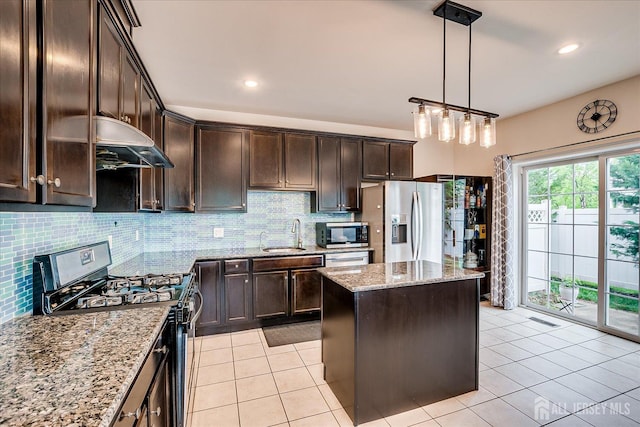 kitchen featuring stainless steel appliances, dark brown cabinetry, extractor fan, decorative backsplash, and light stone countertops