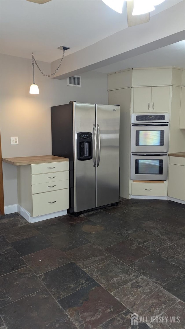 53 Suydam St, New Brunswick, NJ 08901 - kitchen with appliances with stainless steel finishes, stone tile floors, and baseboards