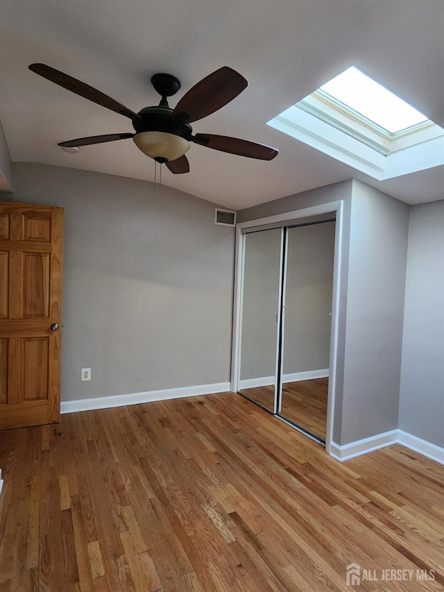 53 Suydam St, New Brunswick, NJ 08901 - unfurnished bedroom featuring a skylight, light wood-type flooring, baseboards, and a closet