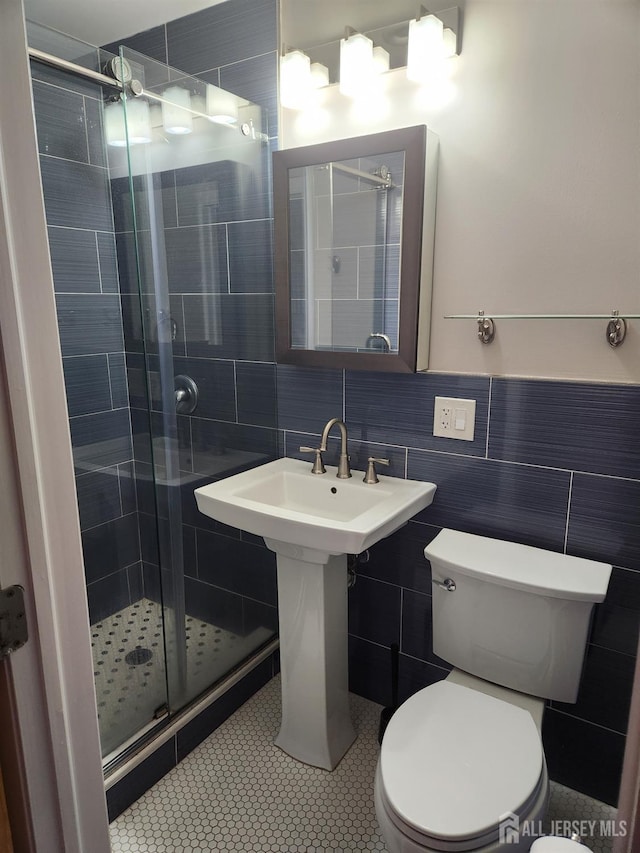 53 Suydam St, New Brunswick, NJ 08901 - bathroom with a stall shower, toilet, tile walls, and tile patterned flooring