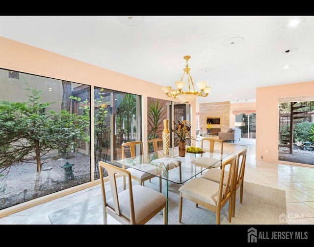 tiled dining room with a notable chandelier