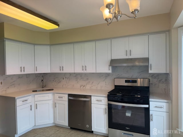 112 Biscayne Ct Unit 8, West Windsor, NJ 08540 - kitchen featuring appliances with stainless steel finishes, under cabinet range hood, a chandelier, light countertops, and white cabinetry