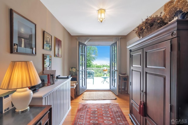 interior space with french doors and light hardwood / wood-style flooring