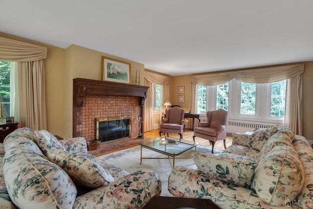 living room with radiator heating unit and a brick fireplace