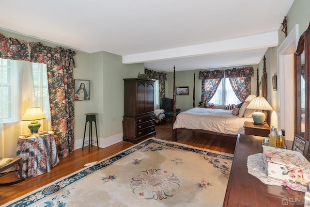 bedroom featuring beamed ceiling and hardwood / wood-style flooring