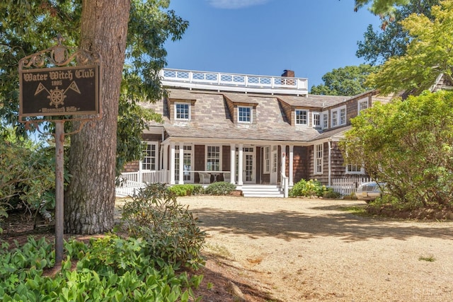 back of house featuring covered porch