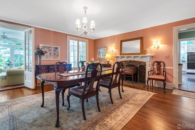 dining room featuring plenty of natural light, dark hardwood / wood-style floors, and a fireplace