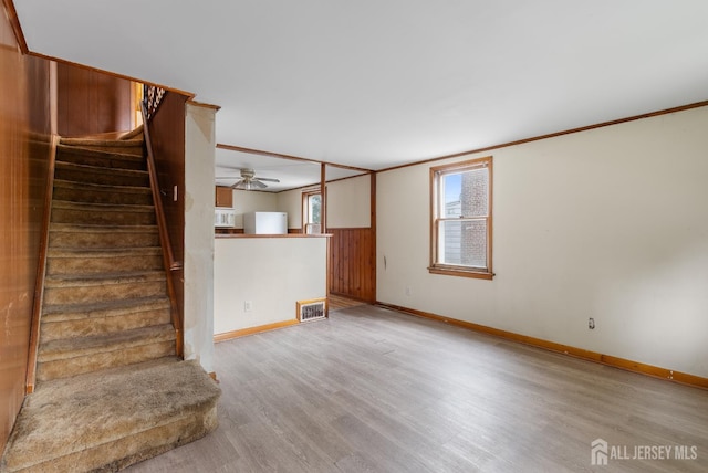 678 Bingle St, Perth Amboy, NJ 08861 - unfurnished living room with light wood-style floors, stairway, baseboards, and crown molding