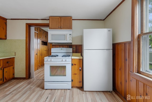 678 Bingle St, Perth Amboy, NJ 08861 - kitchen featuring white appliances, light wood finished floors, brown cabinetry, light countertops, and ornamental molding