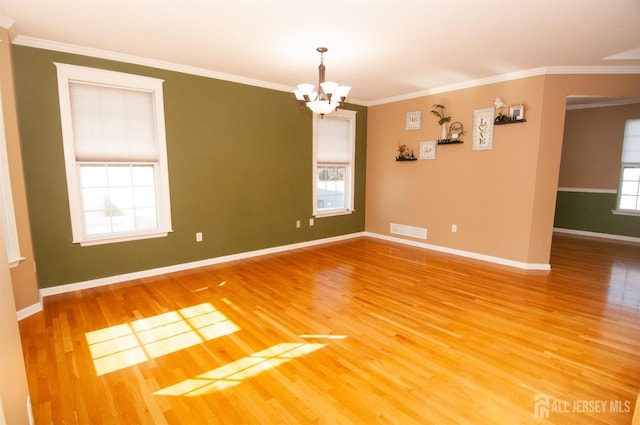 empty room featuring wood-type flooring and crown molding