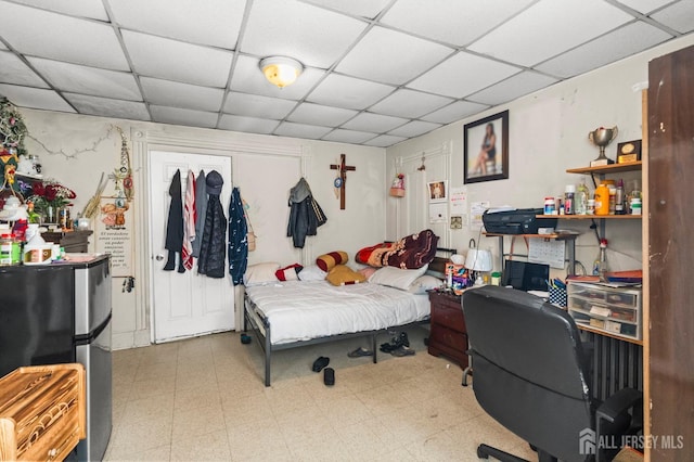209 New St, New Brunswick, NJ 08901 - bedroom featuring freestanding refrigerator, a drop ceiling, and tile patterned floors