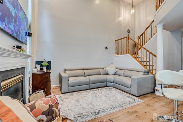 7 Cambridge Ct, East Brunswick, NJ 08816 - living area with a high ceiling, wood finished floors, stairs, and a glass covered fireplace