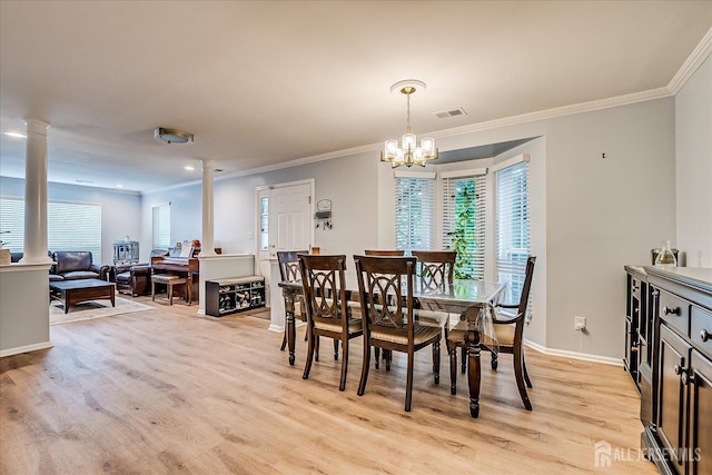 7 Cambridge Ct, East Brunswick, NJ 08816 - dining area featuring ornate columns, crown molding, healthy amount of natural light, light wood-style floors, and a chandelier