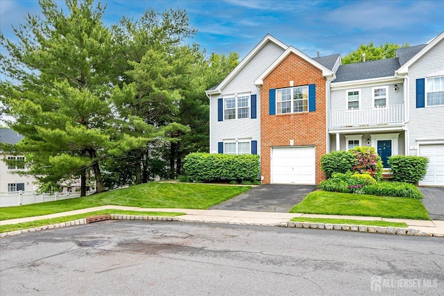 7 Cambridge Ct, East Brunswick, NJ 08816 - view of front facade with driveway, brick siding, a front yard, and a garage