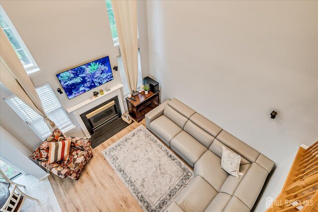 7 Cambridge Ct, East Brunswick, NJ 08816 - living area featuring a towering ceiling, a fireplace with flush hearth, plenty of natural light, and wood finished floors