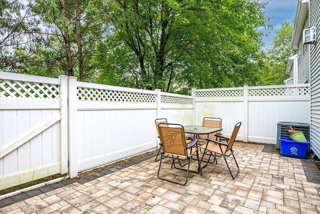7 Cambridge Ct, East Brunswick, NJ 08816 - fenced backyard with a patio area, outdoor dining space, and view of wooded area