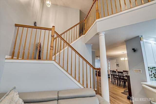 7 Cambridge Ct, East Brunswick, NJ 08816 - staircase featuring wood finished floors, crown molding, a chandelier, and a high ceiling