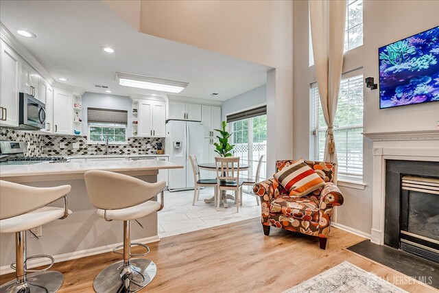 7 Cambridge Ct, East Brunswick, NJ 08816 - living area featuring a fireplace with flush hearth, light wood-style flooring, and recessed lighting