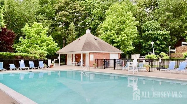 7 Cambridge Ct, East Brunswick, NJ 08816 - community pool featuring a patio and view of scattered trees