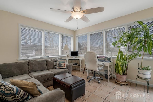 interior space featuring light tile patterned floors, baseboards, and ceiling fan