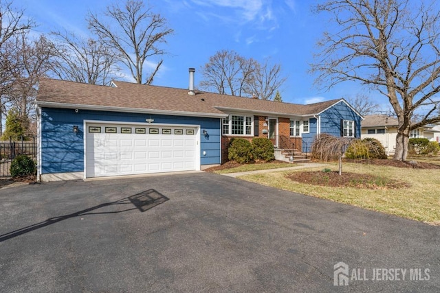 ranch-style home with aphalt driveway, a garage, and fence