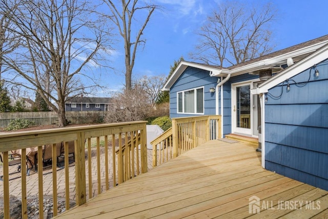 wooden terrace featuring fence