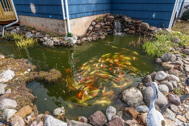 exterior details featuring a small pond