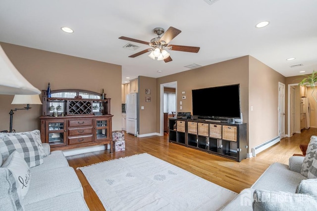 living area with visible vents, a baseboard heating unit, ceiling fan, light wood-type flooring, and recessed lighting