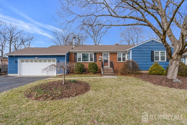 ranch-style home featuring driveway, roof with shingles, a front yard, an attached garage, and brick siding