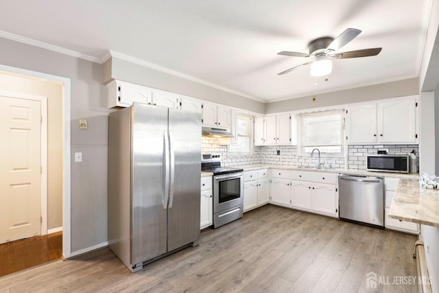 137 Safran Ave, Edison, NJ 08837 - kitchen with appliances with stainless steel finishes, light wood finished floors, white cabinets, light countertops, and crown molding