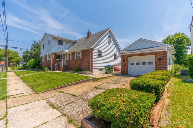 137 Safran Ave, Edison, NJ 08837 - view of side of property with brick siding, a garage, driveway, and a yard