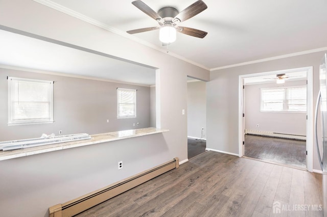 137 Safran Ave, Edison, NJ 08837 - empty room with a baseboard heating unit, ceiling fan, ornamental molding, wood finished floors, and healthy amount of natural light