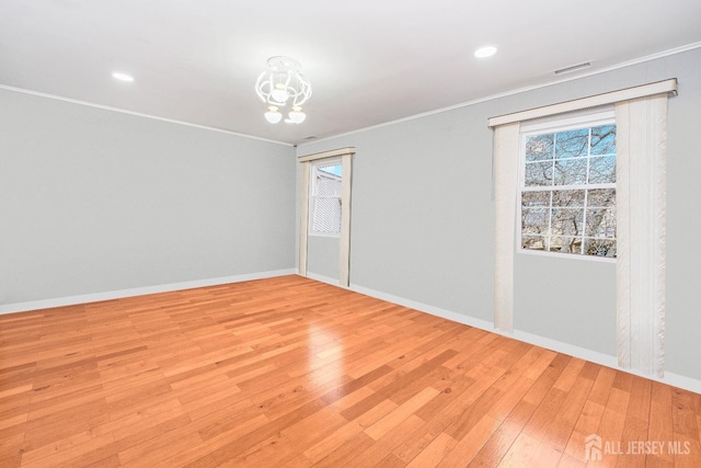 unfurnished room with crown molding, light wood-style flooring, baseboards, a chandelier, and recessed lighting