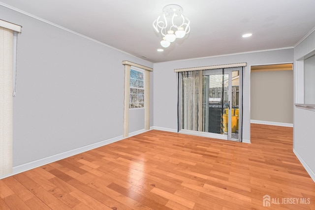 empty room featuring crown molding, light wood-type flooring, baseboards, a chandelier, and recessed lighting