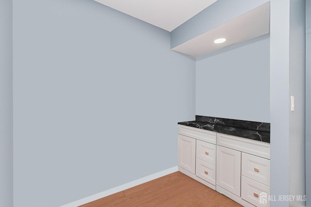 bathroom featuring wood finished floors and baseboards