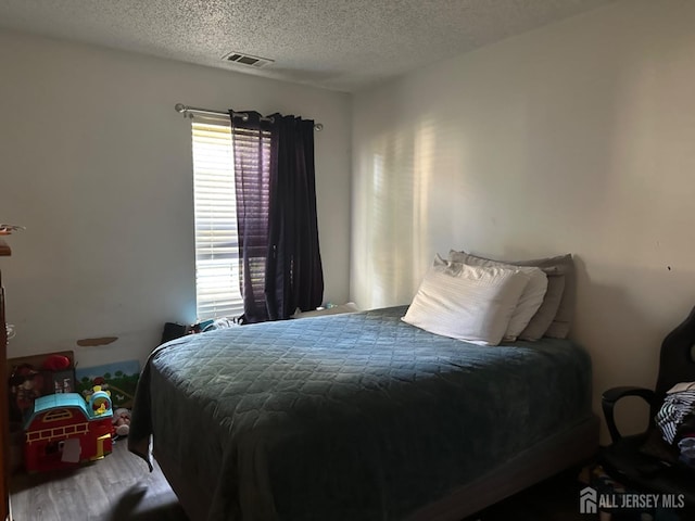 1202 Harbor Club Dr, Sayreville, NJ 08859 - bedroom featuring wood finished floors, a textured ceiling, and visible vents